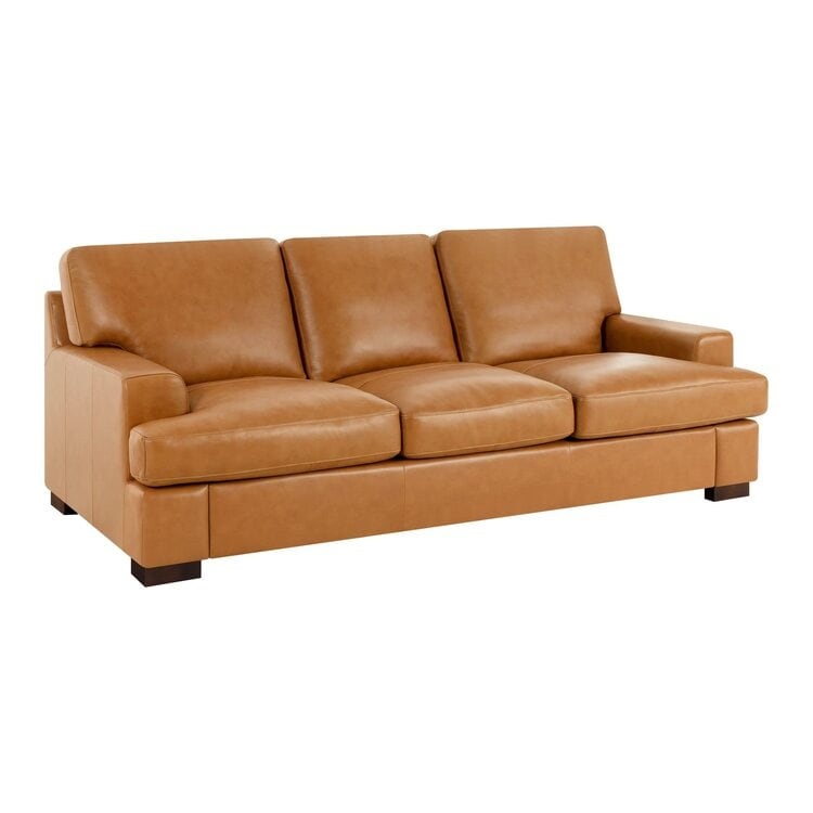Canapé moderne en cuir véritable avec pieds en bois et coussin supplémentaire.
