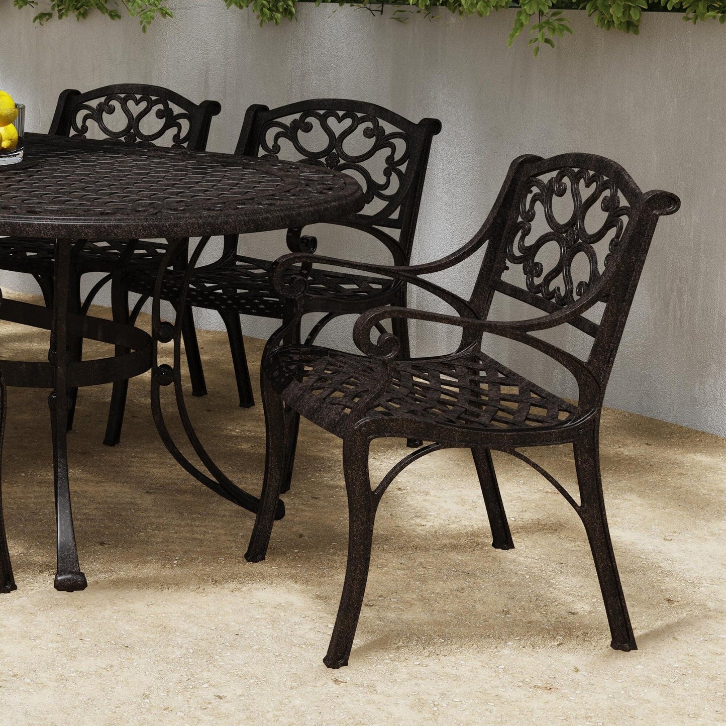Ensemble de salle à manger d'extérieur Sanibel en bronze et aluminium, 7 pièces, comprenant une table ovale de 72 pouces et six chaises à accoudoirs de Homestyles.