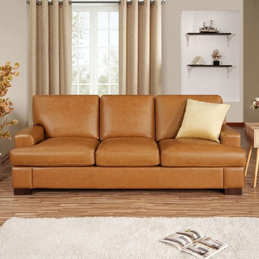 Canapé moderne en cuir véritable avec pieds en bois et coussin supplémentaire.